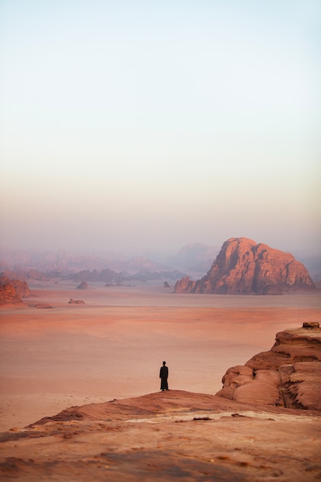 A person standing on top of a sandy hill in Mthatha, South Africa